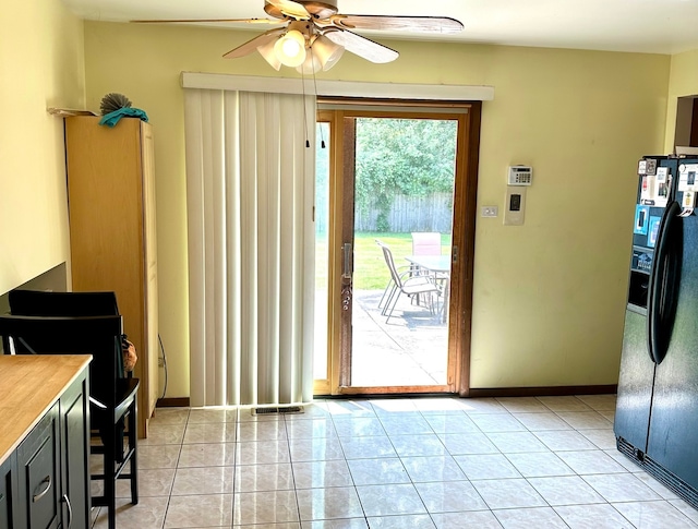 entryway featuring plenty of natural light, ceiling fan, and light tile patterned flooring