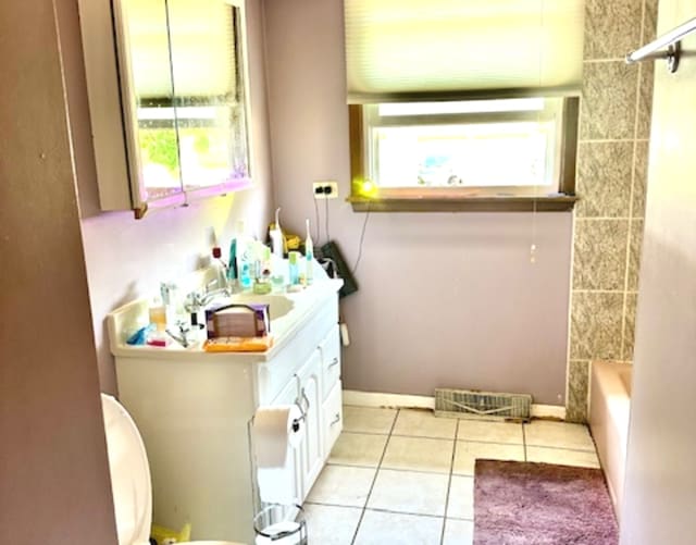 bathroom featuring tile patterned floors, toilet, plenty of natural light, and vanity