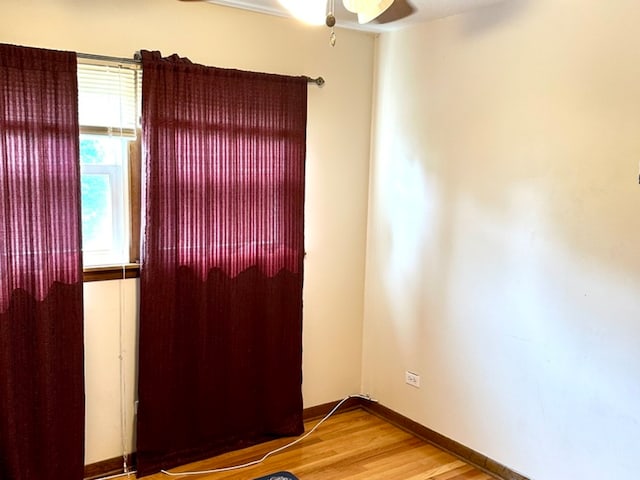 unfurnished room with hardwood / wood-style flooring