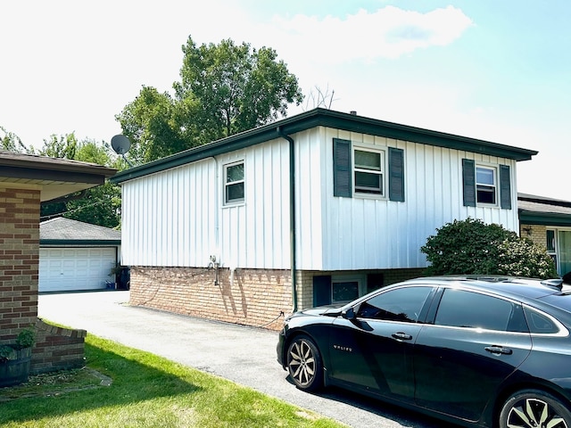 view of front facade with a garage and an outbuilding