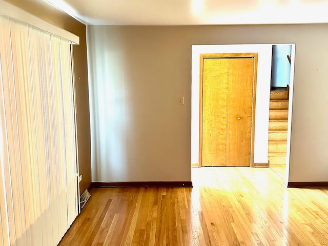 empty room with hardwood / wood-style flooring