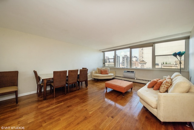 living room with hardwood / wood-style flooring and a baseboard heating unit