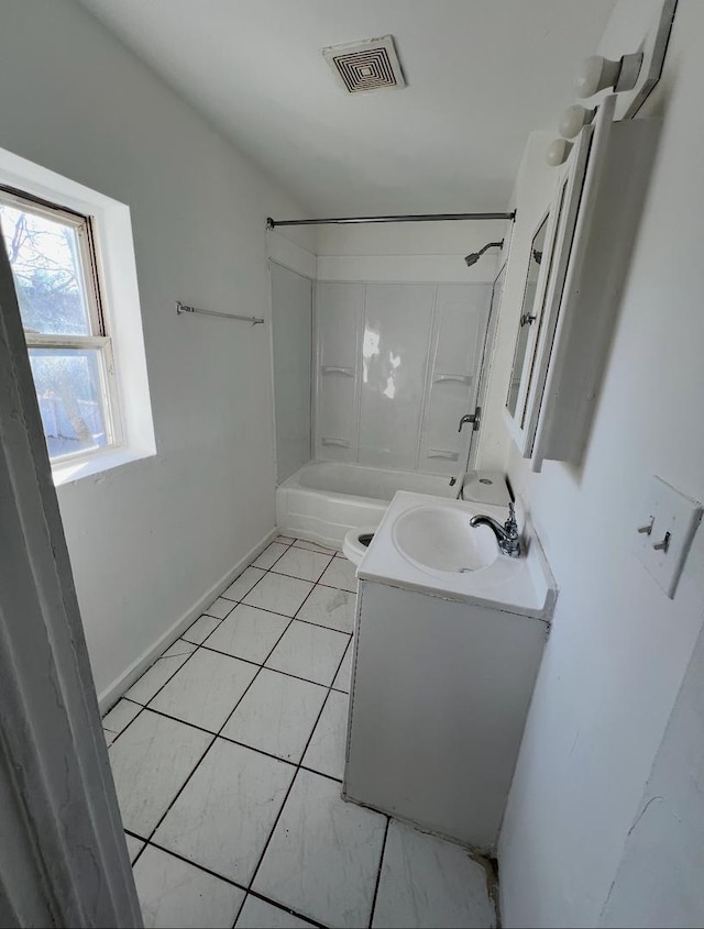 bathroom featuring vanity, baseboards, visible vents, tile patterned flooring, and shower / bathing tub combination