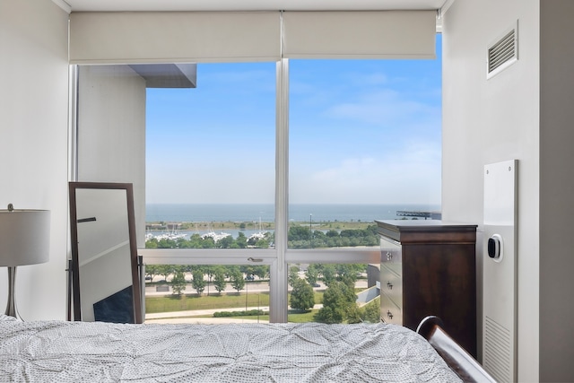 bedroom featuring a water view