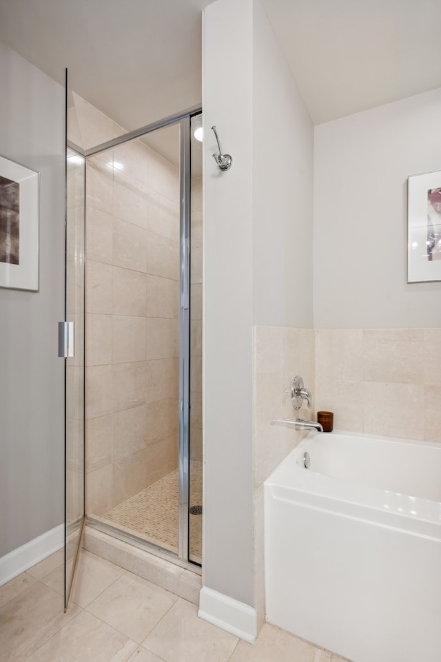 bathroom featuring tile patterned floors and independent shower and bath