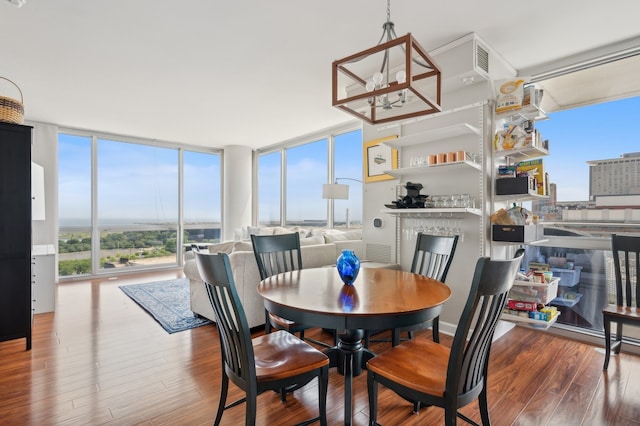 dining space featuring hardwood / wood-style floors and a wall of windows