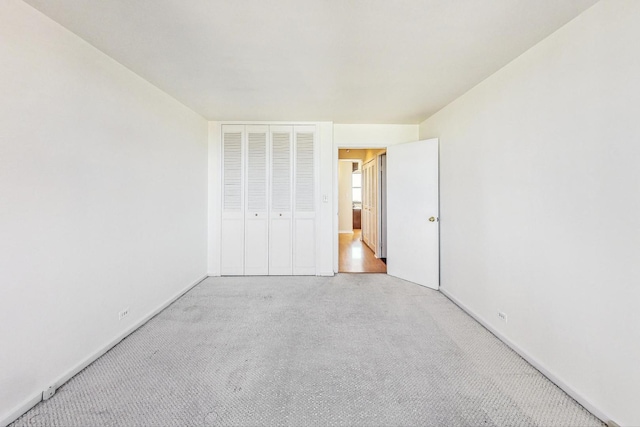 unfurnished bedroom featuring carpet flooring and a closet