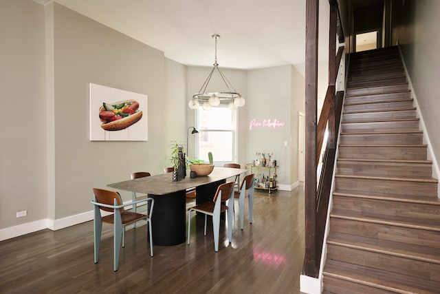 dining room featuring dark hardwood / wood-style flooring and a notable chandelier