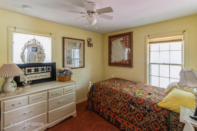 bedroom with ceiling fan and dark colored carpet