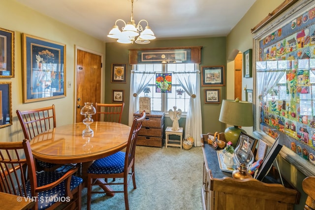 dining area featuring carpet flooring and a notable chandelier