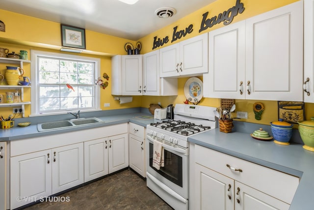 kitchen featuring white cabinetry, sink, and white range with gas stovetop