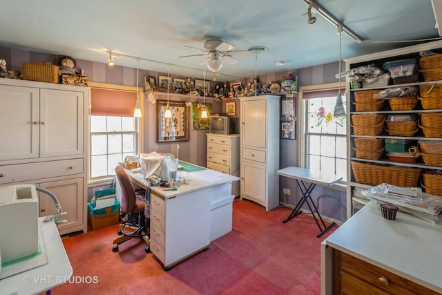 kitchen featuring light countertops, track lighting, carpet, and a center island