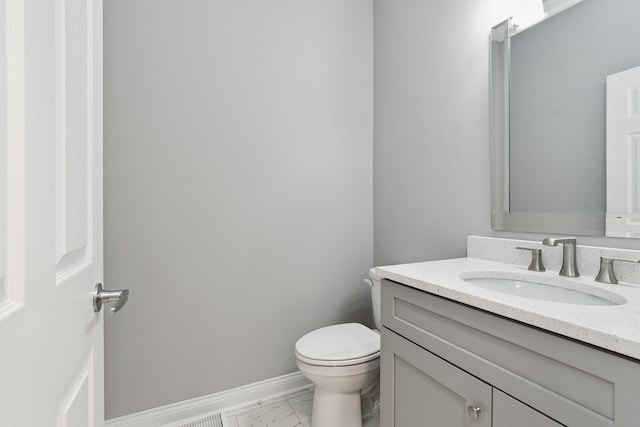 bathroom featuring vanity and toilet