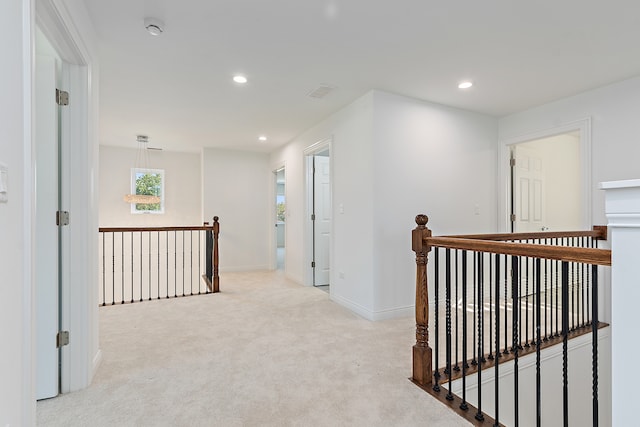 hallway with light carpet