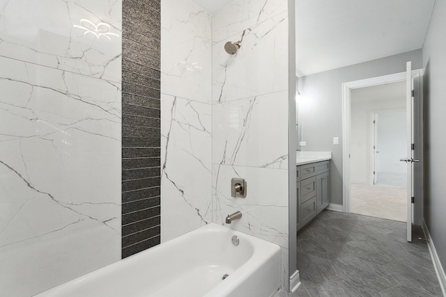 bathroom featuring tiled shower / bath and vanity