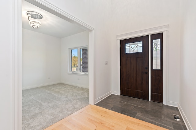 view of carpeted entrance foyer