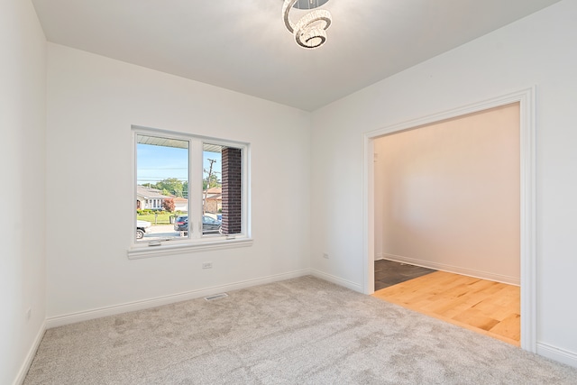 unfurnished room featuring light carpet