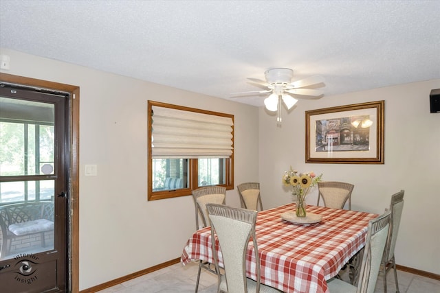 dining room with ceiling fan and a textured ceiling