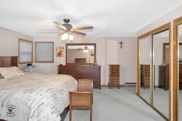 bedroom featuring a baseboard radiator, ceiling fan, and a textured ceiling