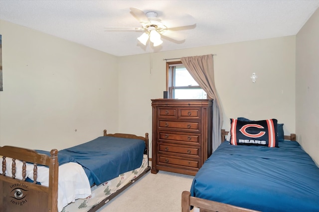 bedroom featuring light carpet and ceiling fan