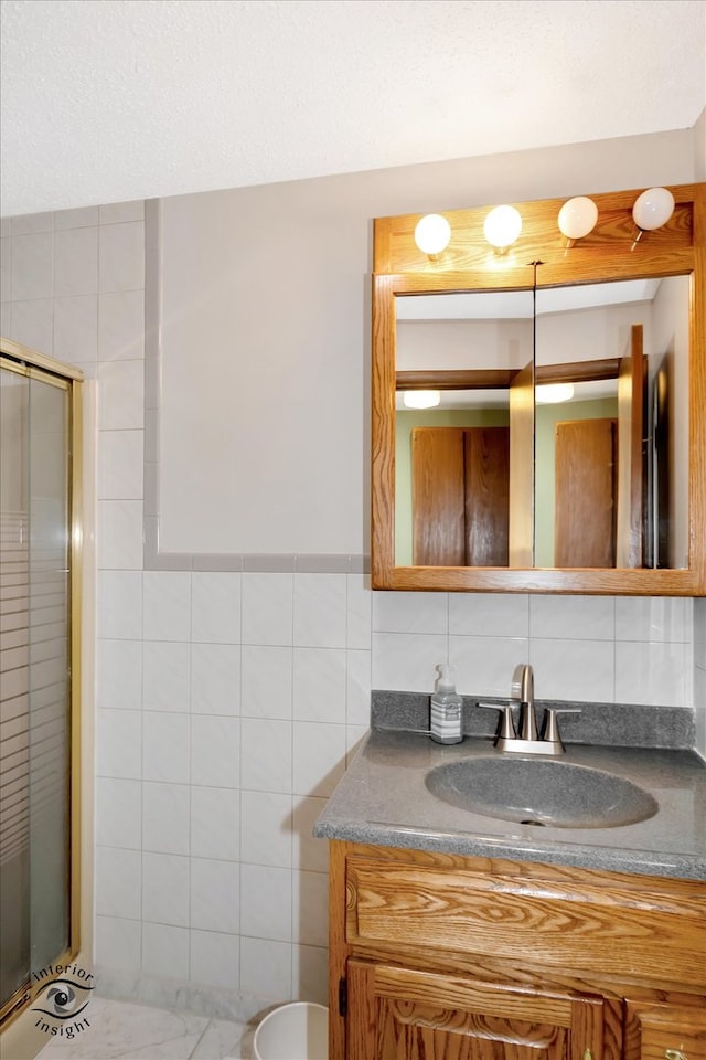 bathroom with tile walls, tasteful backsplash, a shower with shower door, vanity, and toilet