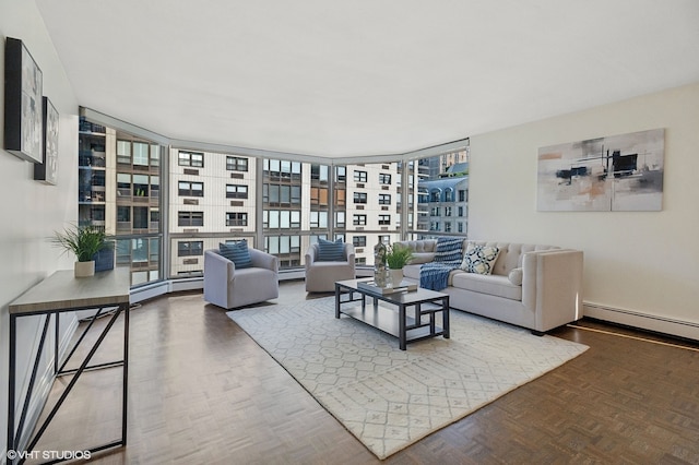 living room with a baseboard heating unit, parquet flooring, and floor to ceiling windows