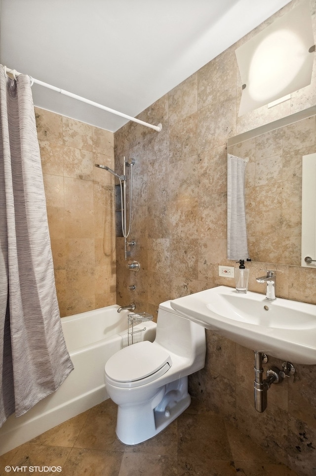 full bathroom with toilet, tile walls, shower / tub combo with curtain, sink, and tile patterned flooring