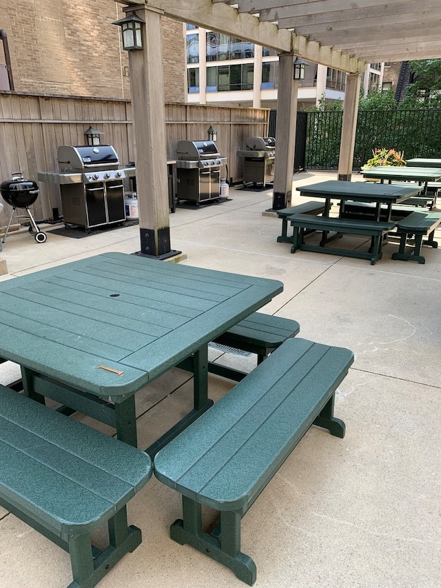 view of patio with a pergola and a grill