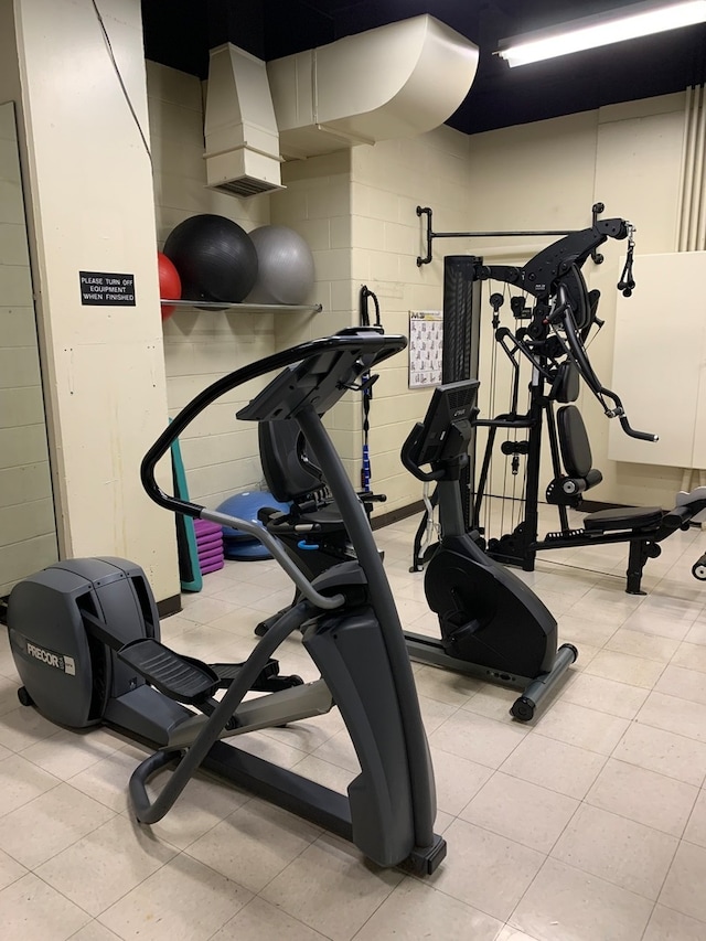 workout area with light tile patterned floors