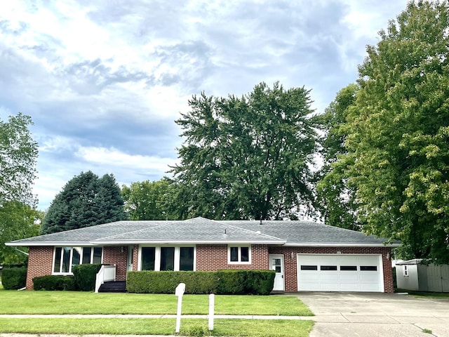 ranch-style home with a shed and a front yard