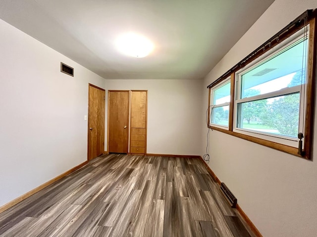 unfurnished bedroom featuring dark wood-type flooring