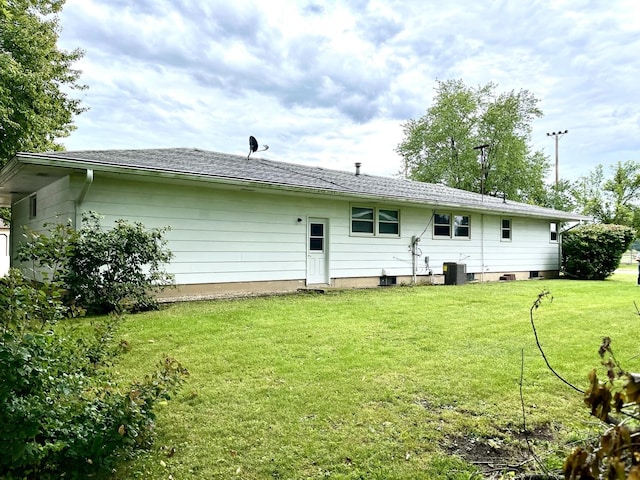 back of property with a yard and cooling unit