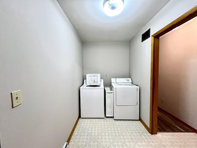 clothes washing area with washing machine and dryer