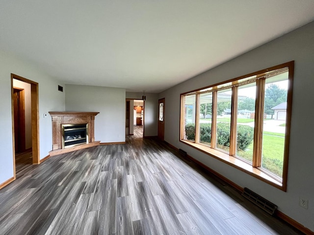 unfurnished living room with dark wood-type flooring