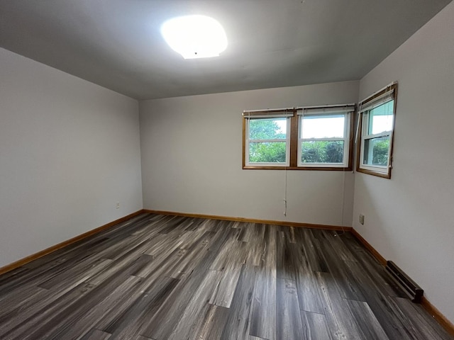 empty room featuring dark wood-type flooring