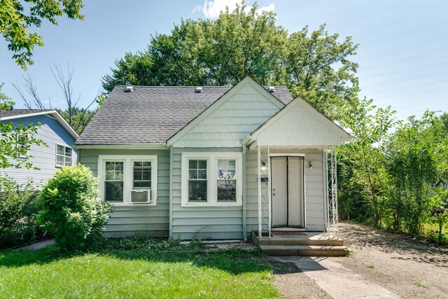 bungalow-style home with a front yard