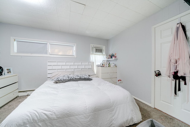 bedroom with a baseboard heating unit and light carpet