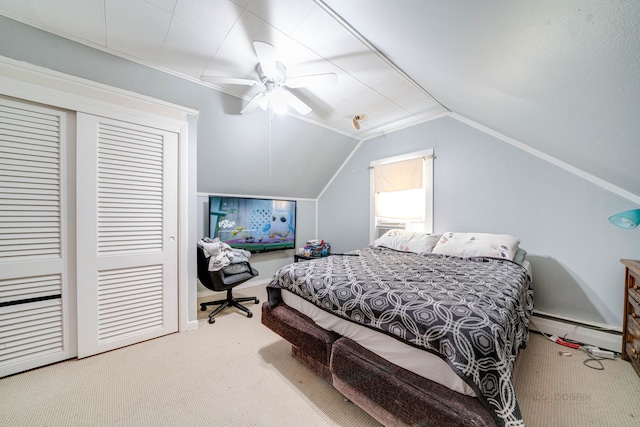 bedroom with ceiling fan, a baseboard heating unit, carpet, vaulted ceiling, and a closet