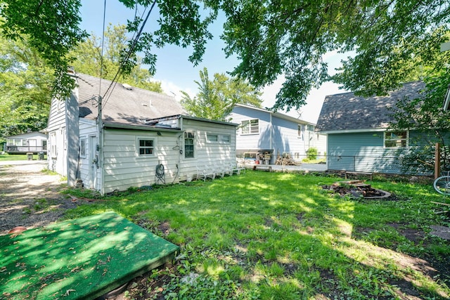 rear view of property with a yard