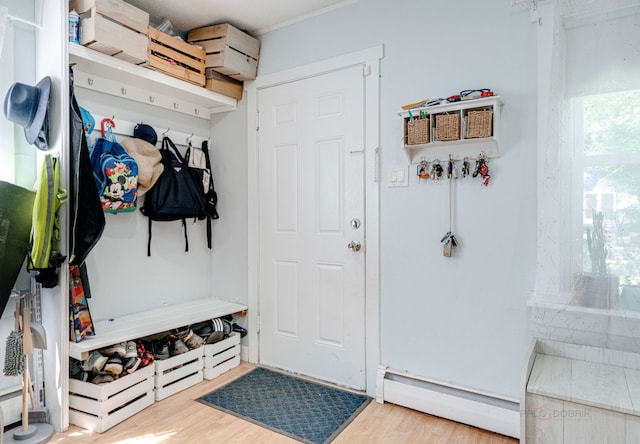 mudroom with a baseboard radiator and hardwood / wood-style floors