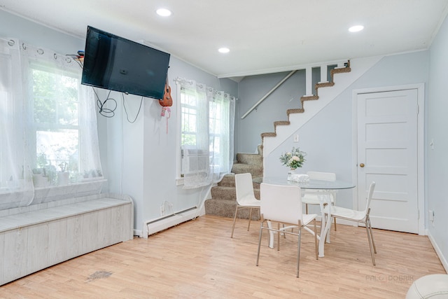 interior space featuring hardwood / wood-style flooring, a baseboard radiator, and cooling unit