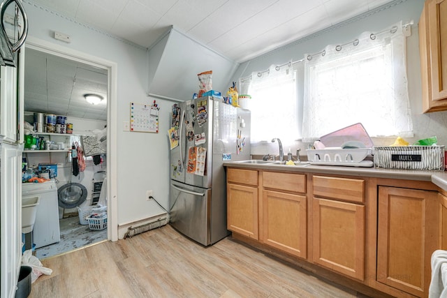 kitchen featuring stainless steel fridge, light hardwood / wood-style floors, and sink