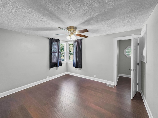 spare room featuring ceiling fan, a textured ceiling, and dark hardwood / wood-style flooring