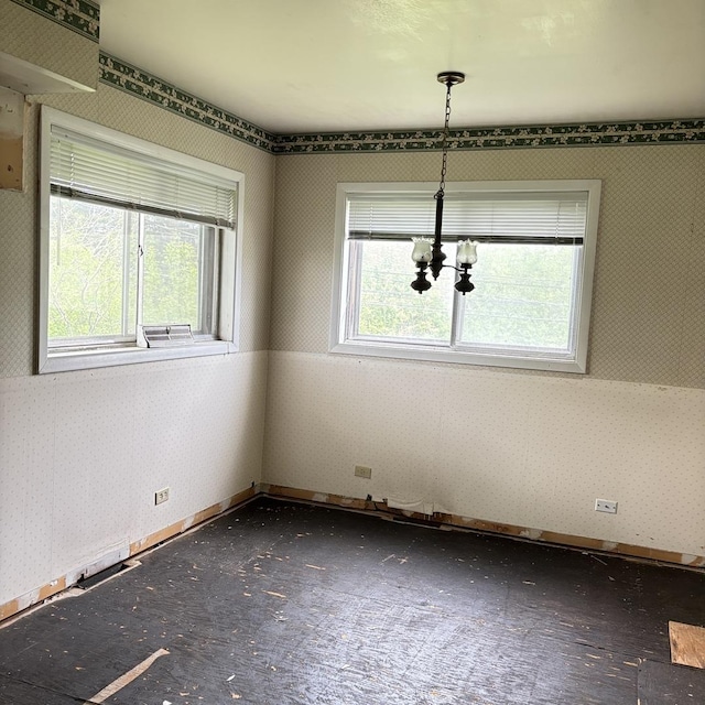 137 Julie Dr, Glenview, IL 60025 - empty room featuring wallpapered walls, a chandelier, and baseboards