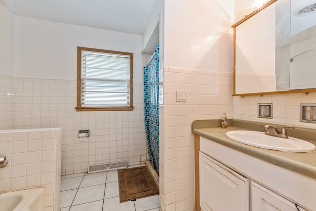 bathroom with tile walls, backsplash, vanity, and tile patterned flooring