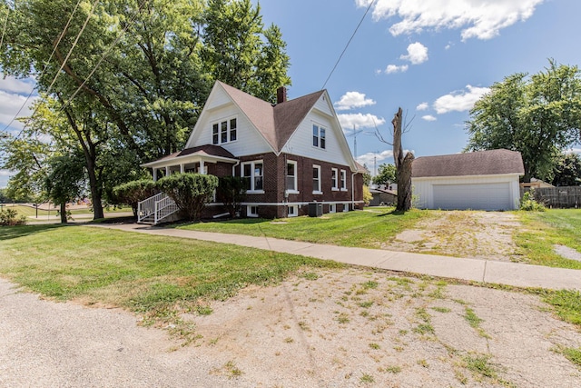 view of front of house featuring brick siding, an outdoor structure, and a front lawn