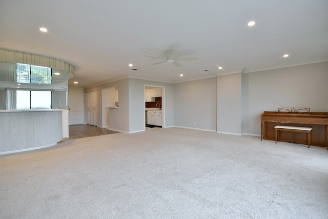 unfurnished living room featuring ceiling fan, light carpet, and crown molding