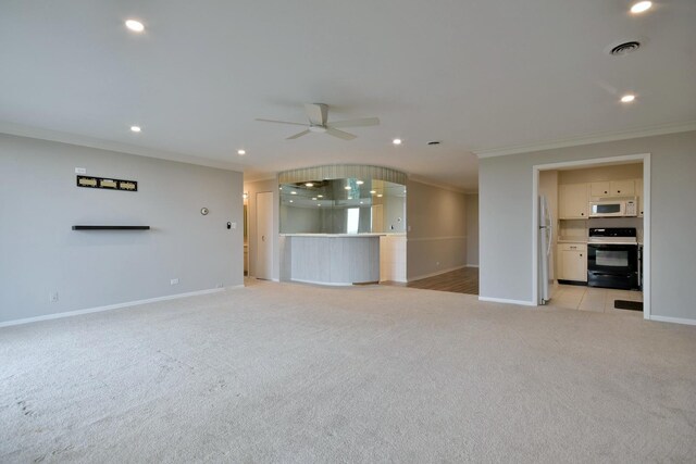 unfurnished living room with ceiling fan, crown molding, and light tile patterned floors