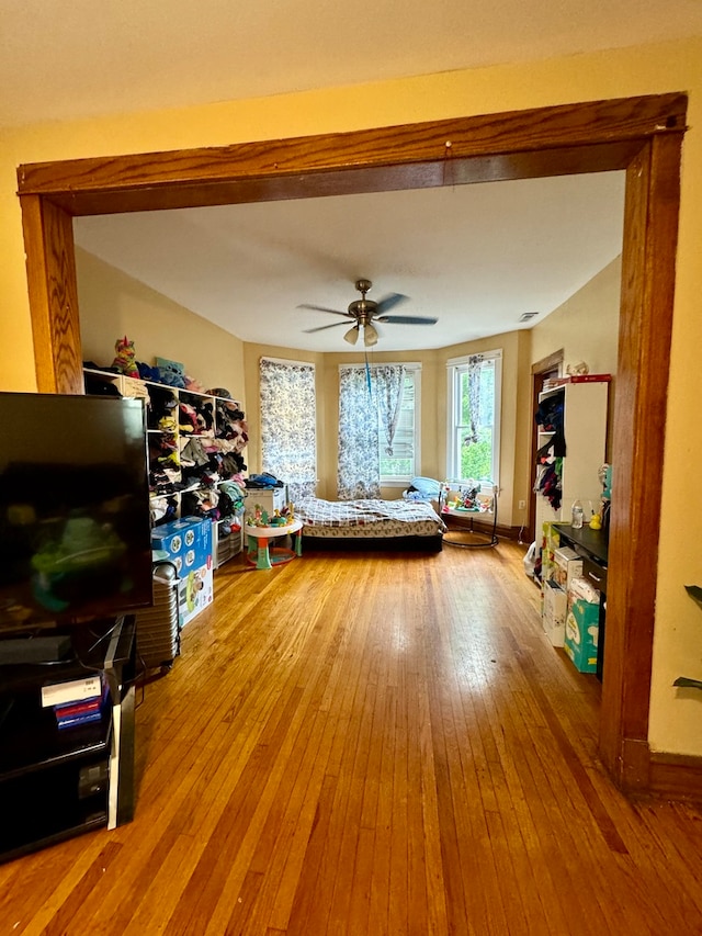 living room featuring hardwood / wood-style floors and ceiling fan