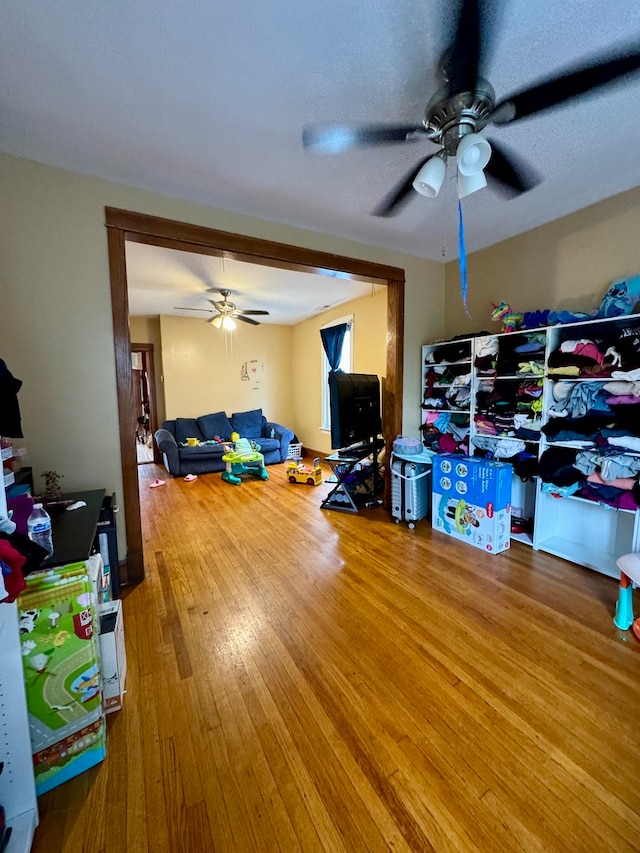 living room featuring ceiling fan and wood-type flooring